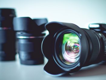 A closeup of a digital camera with lenses